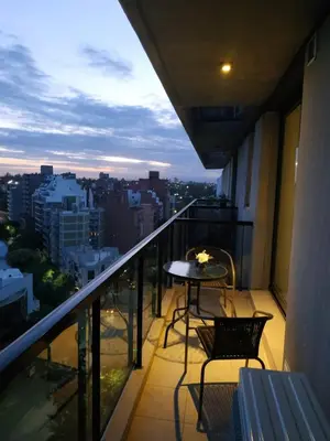 a balcony with a table and chairs and a view at Skyline Córdoba in Cordoba