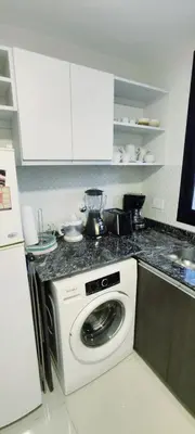 a kitchen with a washing machine in a kitchen at Skyline Córdoba in Cordoba