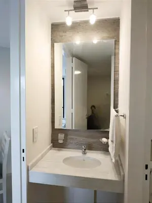 a bathroom with a sink and a large mirror at Skyline Córdoba in Cordoba