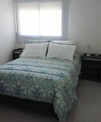 a bed in a bedroom with a window and a pillow at Skyline Córdoba in Cordoba
