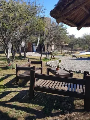a group of benches sitting in a park at Amaneciendo cabañas in Merlo