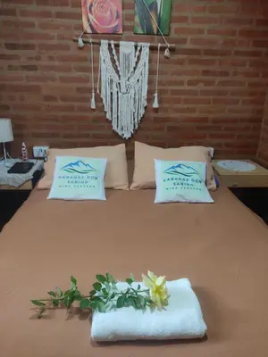 a bed with towels and flowers on top of it at Don Sabino in Arroyo de Los Patos