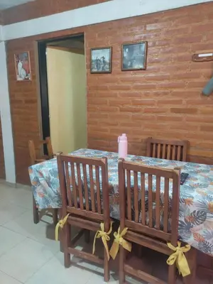 a table with two chairs and a pink candle on it at Don Sabino in Arroyo de Los Patos