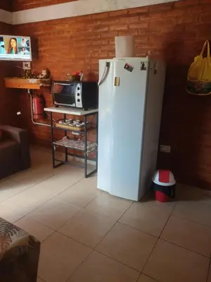 a white refrigerator in a kitchen with a microwave at Don Sabino in Arroyo de Los Patos