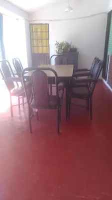 a dining room with a table and chairs at Casa centrica con Piscina in Mina Clavero