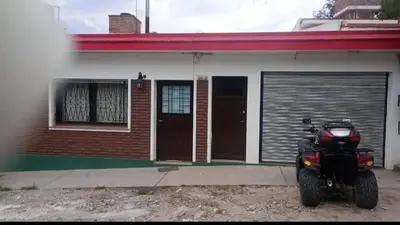 a motorcycle parked in front of a house at Casa centrica con Piscina in Mina Clavero