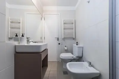 a white bathroom with a sink and a toilet at Av Velez Sarsfield B Nueva Córdoba in Cordoba