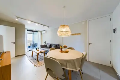 a living room with a table and a couch at Av Velez Sarsfield B Nueva Córdoba in Cordoba