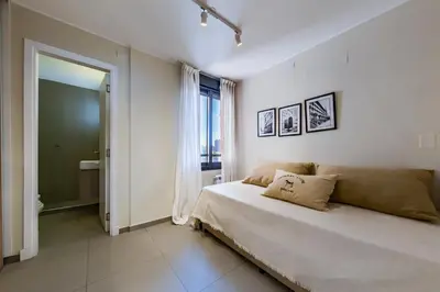 a white bedroom with a large bed and a window at Av Velez Sarsfield B Nueva Córdoba in Cordoba