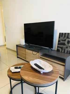 a living room with a table and a tv at Av Estrada 48 B Nueva Córdoba in Cordoba