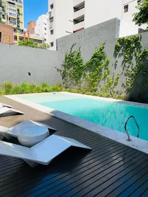 a toilet sitting on a deck next to a swimming pool at Av Estrada 48 B Nueva Córdoba in Cordoba