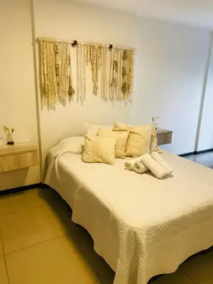 a bedroom with a bed with white sheets and pillows at Av Estrada 48 B Nueva Córdoba in Cordoba