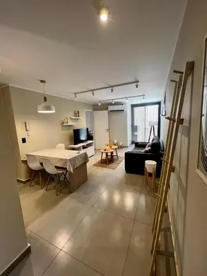 a living room with a table and a couch at Lima 1300 B General Paz in Cordoba