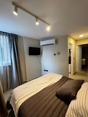 a bedroom with a large bed and a television at Lima 1300 B General Paz in Cordoba