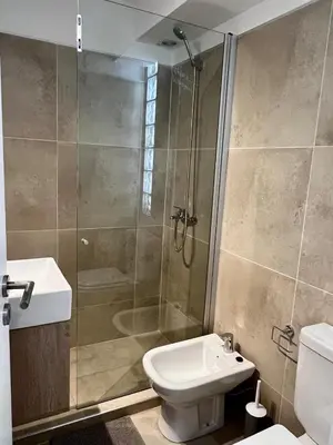 a bathroom with a shower and a toilet and a sink at Lima 1300 B General Paz in Cordoba