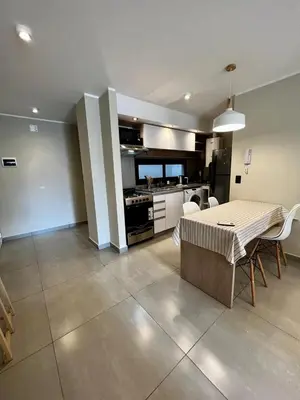 a kitchen and a dining room with a table and chairs at Lima 1300 B General Paz in Cordoba