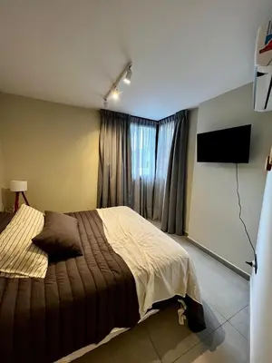 a bedroom with a large bed and a window at Lima 1300 B General Paz in Cordoba