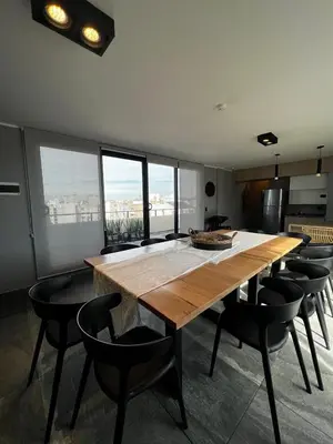 a dining room with a large wooden table and chairs at Lima 1300 B General Paz in Cordoba