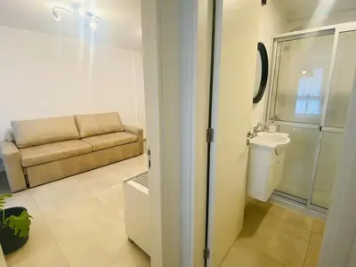 a bathroom with a couch and a sink and a toilet at Arturo M Bas B Güemes in Cordoba
