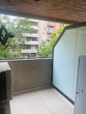 an open door to a balcony with a view of a building at Arturo M Bas B Güemes in Cordoba