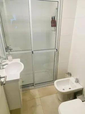 a bathroom with a shower and a toilet and a sink at Arturo M Bas B Güemes in Cordoba