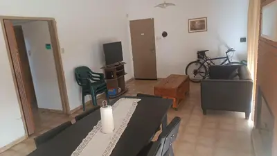 a living room with a table and chairs at Casa Ayeya in Villa Carlos Paz