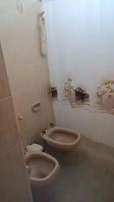 a bathroom with a toilet and a bidet at Casa Ayeya in Villa Carlos Paz