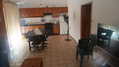 a kitchen with a table and chairs and a dining room at Casa Ayeya in Villa Carlos Paz