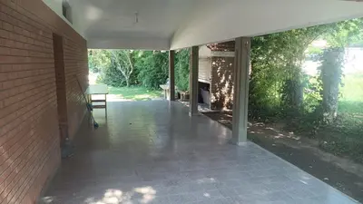 an empty hallway of a house with a brick wall at Casa Ayeya in Villa Carlos Paz