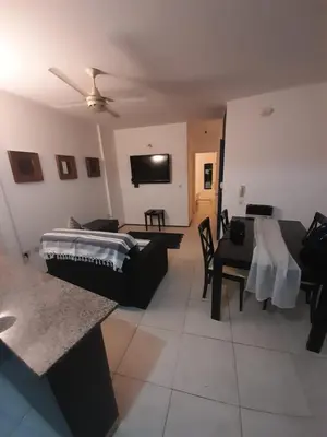 a living room with a bed and a couch at Departamento a metros peatonal Carlos Paz in Villa Carlos Paz