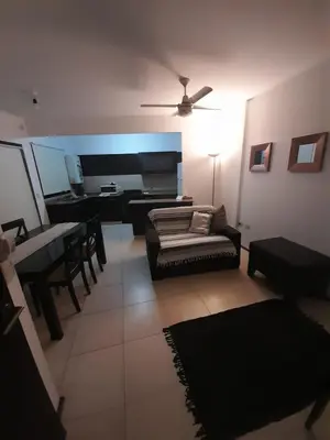 a living room with a couch and a table at Departamento a metros peatonal Carlos Paz in Villa Carlos Paz