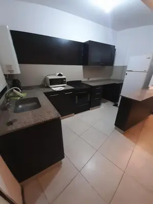 a small kitchen with a sink and a microwave at Departamento a metros peatonal Carlos Paz in Villa Carlos Paz