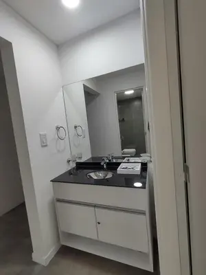 a bathroom with a sink and a mirror at Sam 1 Sampaoli in Villa Carlos Paz