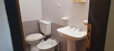 a small bathroom with a toilet and a sink at Todo cerca in Mina Clavero