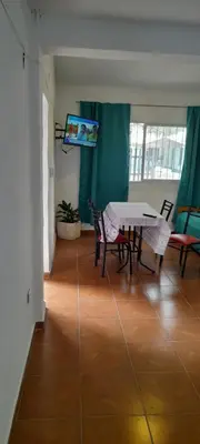 a dining room with a table and chairs in a room at Todo cerca in Mina Clavero