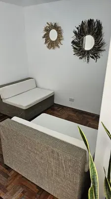 a room with two beds and mirrors on the wall at Apartamento en Nueva Córdoba in Cordoba
