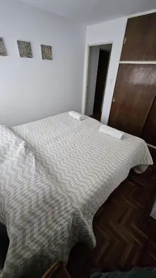 a bedroom with a bed with a blanket on it at Apartamento en Nueva Córdoba in Cordoba