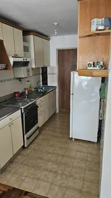 a kitchen with a white refrigerator and a stove at Apartamento en Nueva Córdoba in Cordoba