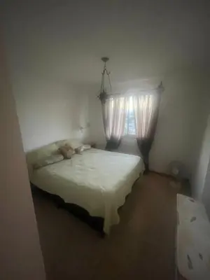 a small bedroom with a bed with a window at Cielos de Güemes in Cordoba