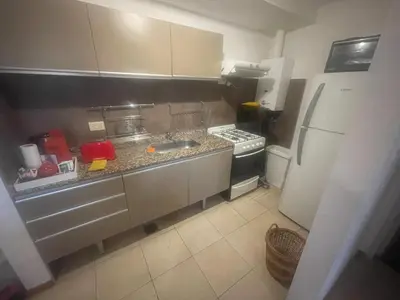 a small kitchen with a sink and a refrigerator at Cielos de Güemes in Cordoba