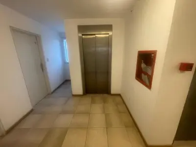an empty hallway with a door and a tile floor at Cielos de Güemes in Cordoba