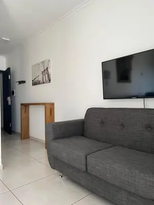 a living room with a couch and a flat screen tv at Two paxs in Cordoba