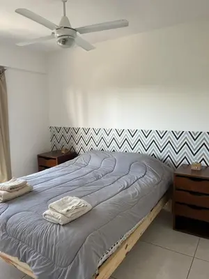 a bedroom with a bed with a ceiling fan at Two paxs in Cordoba