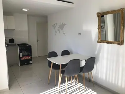 a table and chairs in a room with a mirror at Two paxs in Cordoba