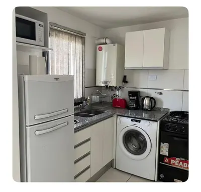 a kitchen with a washing machine and a washer at Two paxs in Cordoba