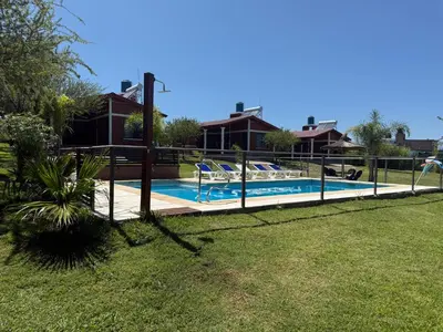 a house with a swimming pool in a yard at Cabañas AdamiS 2 in Villa Cura Brochero
