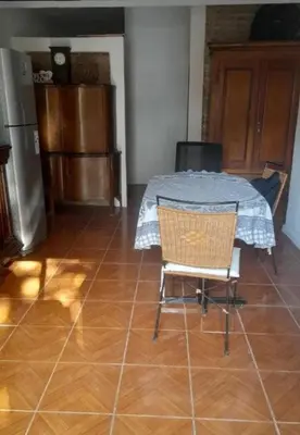a kitchen with a table and a chair in a room at Casa Valle Buena Esperanza in Alta Gracia