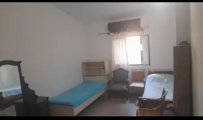 a small bedroom with a bed and a window at Casa Valle Buena Esperanza in Alta Gracia