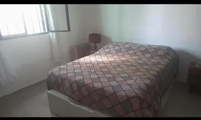 a bed sitting in a room with a window at Casa Valle Buena Esperanza in Alta Gracia