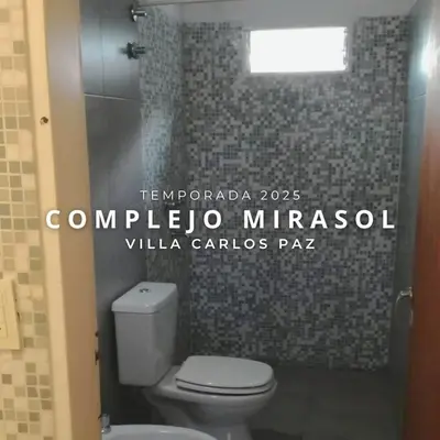 a bathroom with a white toilet and a window at Complejo Mirasol en Carlos Paz in Villa Carlos Paz